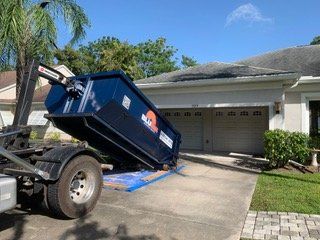 BluBin roll-off truck dropping off a dumpster at a home